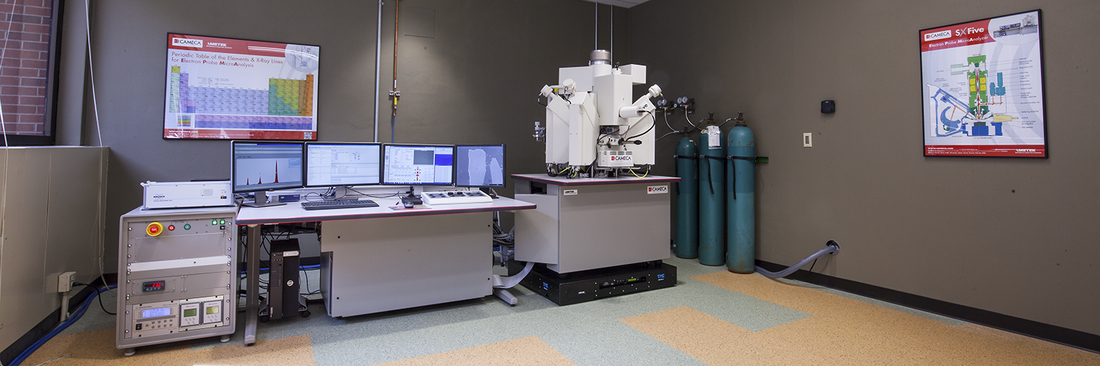 Electron microprobe laboratory featuring a Cameca SXFive electron probe microanalyzer, workstation with multiple monitors, and supporting analytical equipment.